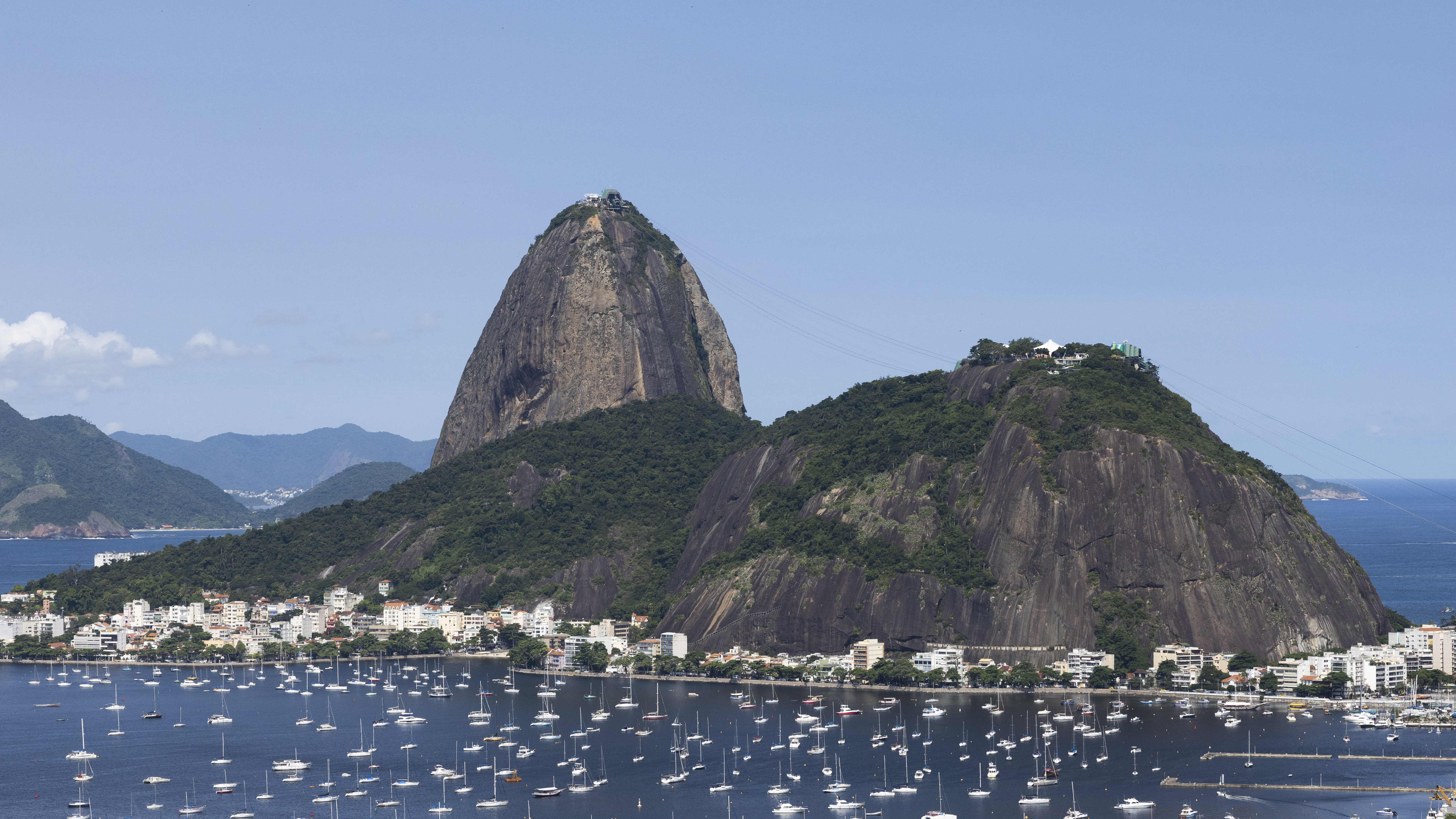 A picture of Sugarloaf mountain from the cable car deck where tourists take pictures of the sights